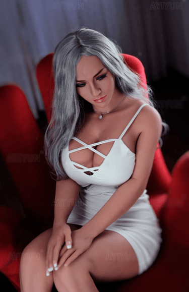 a woman in a white dress sitting on a red chair